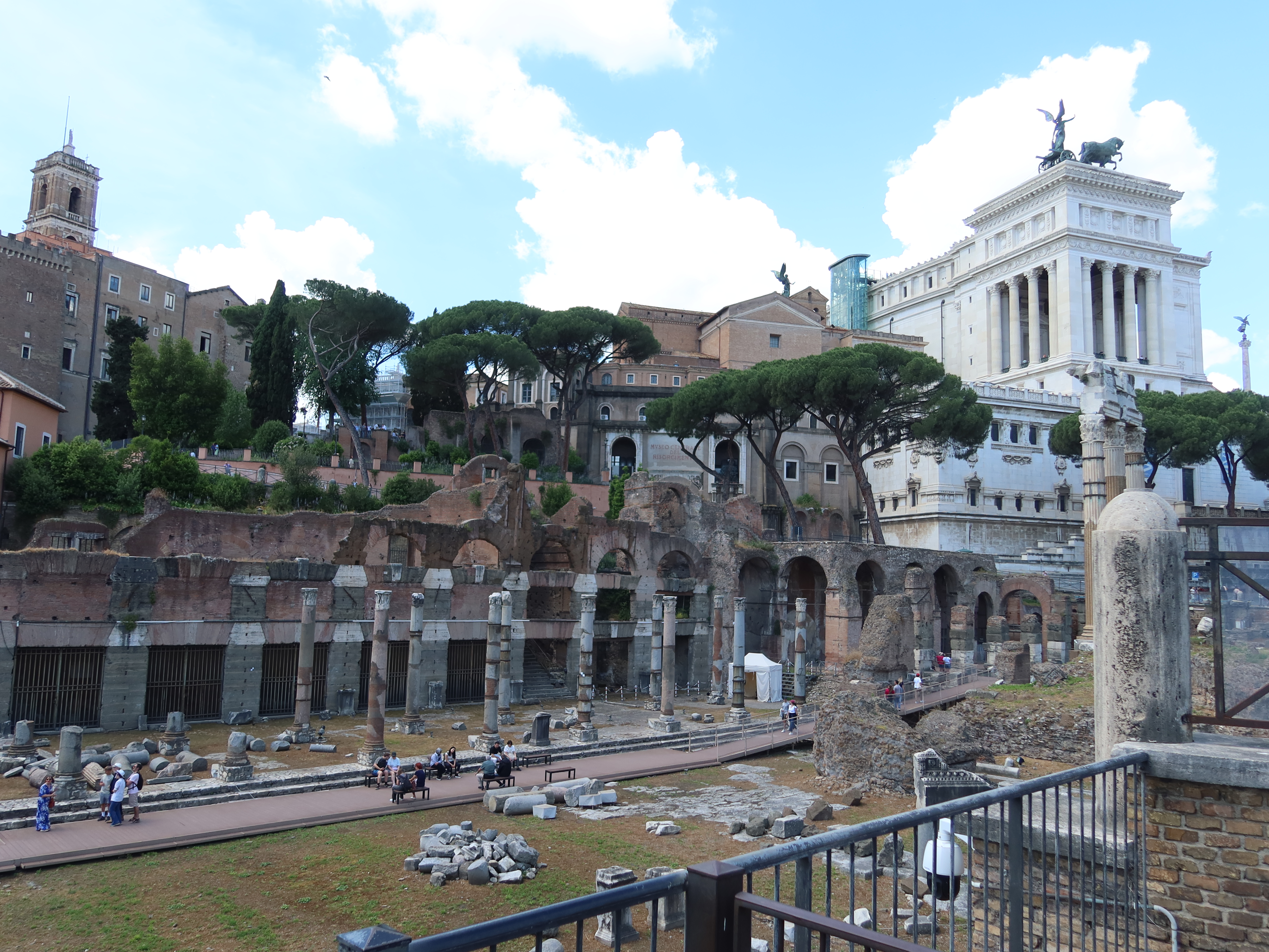 Roman Ruins with Neoclassical Building Background Ancient Roman ruins with stone columns and a neoclassical building in the background.
